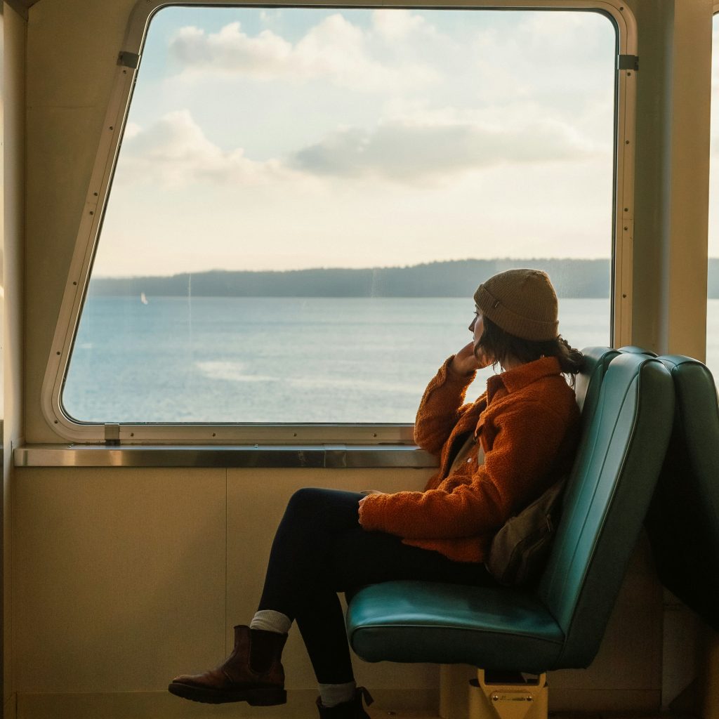Tourist seated in middle of fast boat cabin